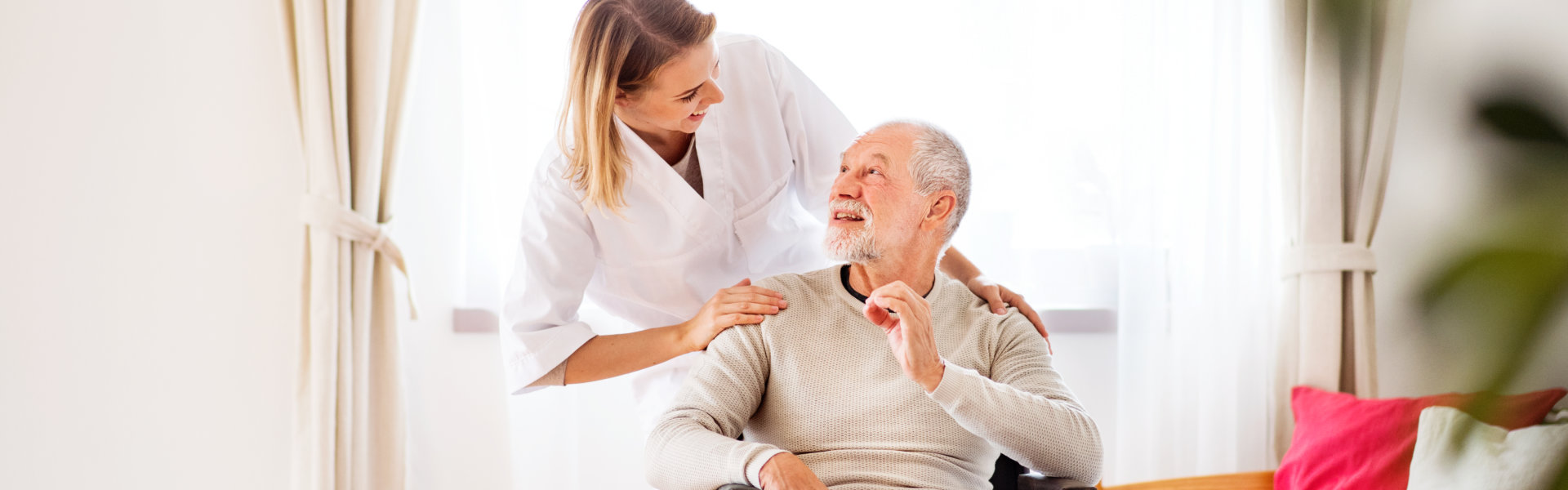 caregiver and senior man in a wheelchair