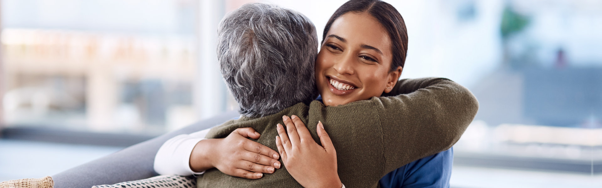 caregiver hugging the elderly woman