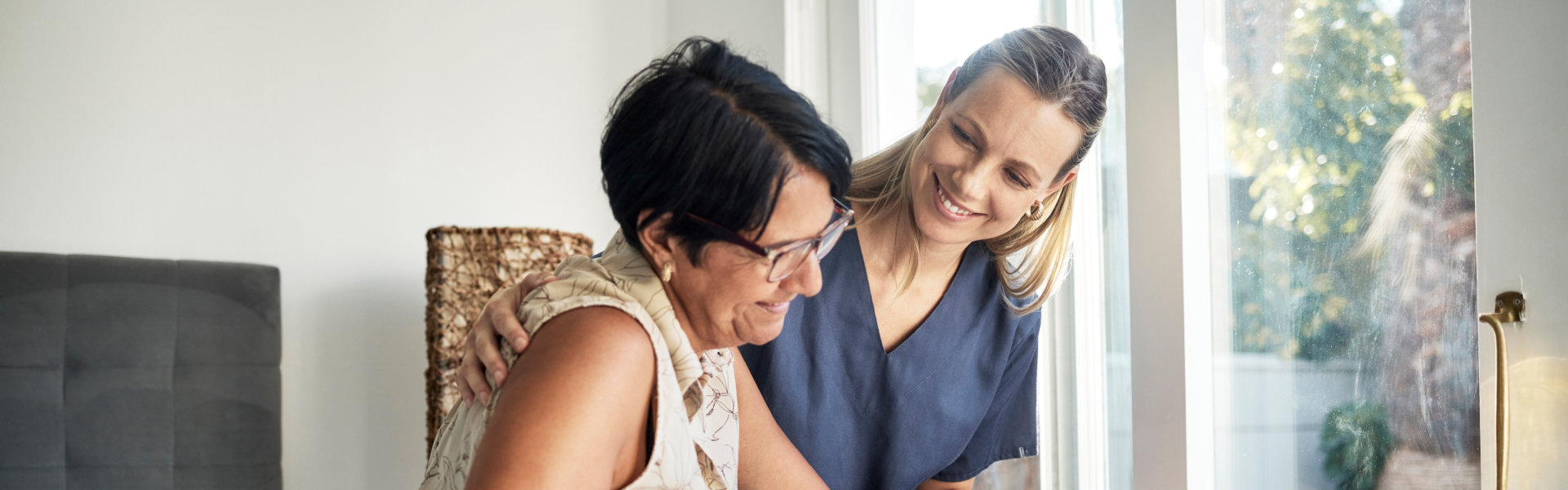 caregiver helping the senior woman walk