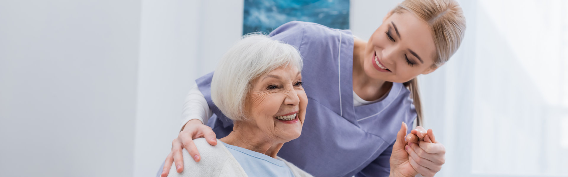 smiling senior woman and her caregiver