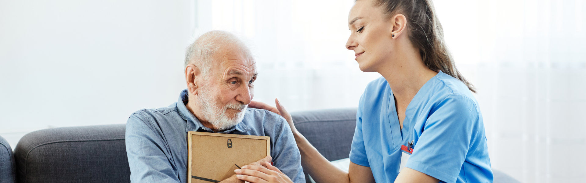 caregiver comforting the senior man