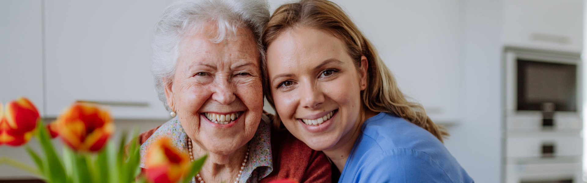 happy caregiver and senior woman